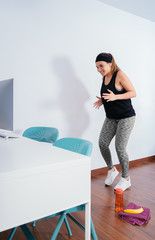 Woman training from home with an online exercise class