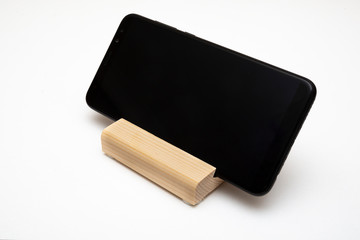Wooden stand for smartphone isolated