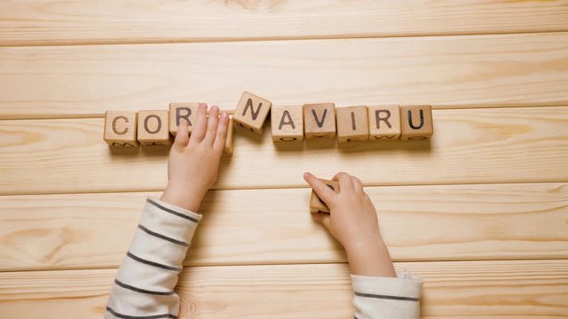 Children and coronavirus pandemics. COVID-19 background. Kids hands laying out coronavirus word. Pandemic, epidemic and child. Quarantine, children at home. Home school. E learning background