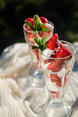 Fresh strawberries with yoghurt and whipped cream. Breakfast time. Healthy food. Delicious dessert sugar free. Vegetarian dish. Spring time 