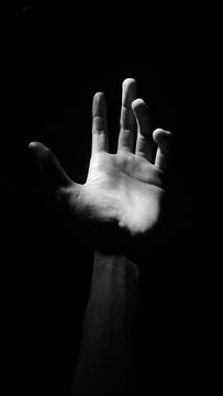 Cropped Hand Of Man Against Black Background