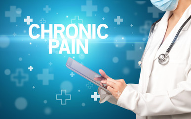 doctor writes notes on the clipboard with CHRONIC PAIN inscription, first aid concept