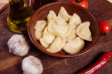 vareniki with cheese are Ukrainian foods on a wood background