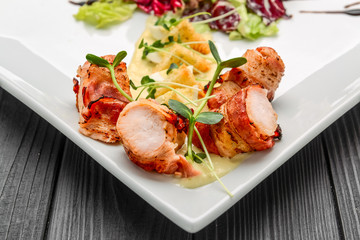 Grilled meat rolls wrapped in strips of bacon