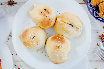 Top view of tandir samsa - popular asian pastries - on white plate.