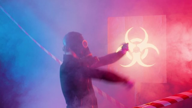 4k Crazy human in gas mask dancing against a background of thick smoke during a bacteriological hazard. Man in gas mask not afraid of coronavirus and dancing.