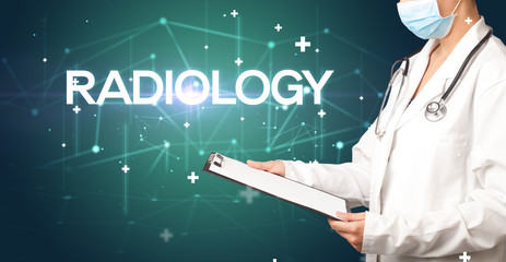Doctor fills out medical record with RADIOLOGY inscription, medical concept