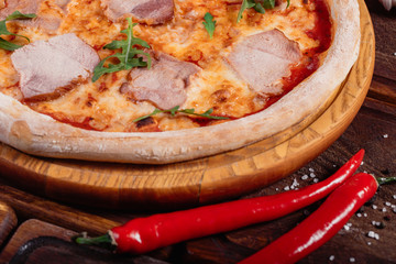 Pizza with sliced vegetables on rustic wood, vintage style