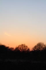 Beautiful and vibrant sunset, with the colours changing from a pink/orange colour into a clear blue sky