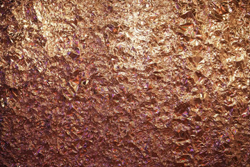 Wall of golden crumpled foil paper.