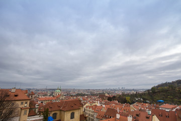 Panorama of Prague, Czech Republic, seen from the top of the castle, during an autumn cloudy afternoon. Major tourist landmarks such as medieval towers, cathedrals and churches, are visible