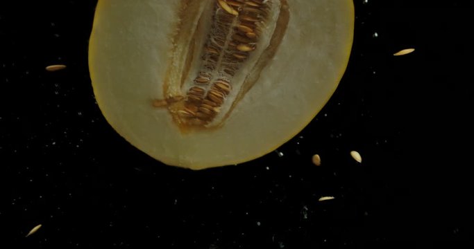 Half the melon falls under water with air bubbles.