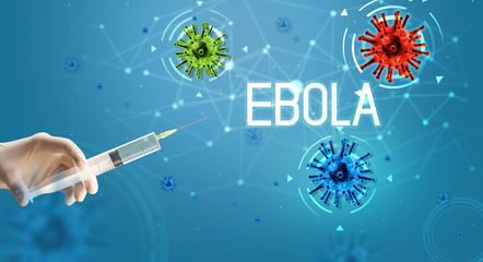 Syringe, medical injection in hand with EBOLA inscription, coronavirus vaccine concept