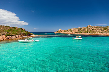 Naklejka premium Panoramic view of the pink granite rock formations and the clear and transparent waters in the Maddalena archipelago in Sardinia, Italy.