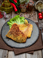 Pieces of fried fish, carp, on a ceramic plate