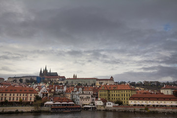 Fototapeta na wymiar Panorama of the Old Town of Prague, Czech Republic, in autumn, at fall, with Hradcany hill and the Prague Castle with the St Vitus Cathedral (Prazsky hill) seen from Vltava river. 