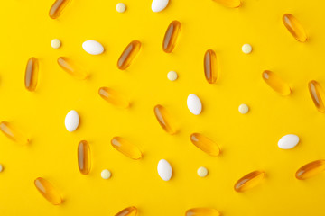 Many scattered pharmaceutical medicine vitamins, pills, fish oil softgel, tablets