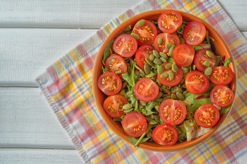 Salad of fresh cherry tomatoes on a plate , close up,top view.