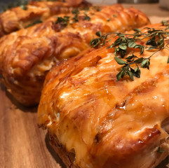 ready-made baked and ruddy salmon fillet souffle decorated with thyme sprigs lies on a wooden board on a table to prepare for serving