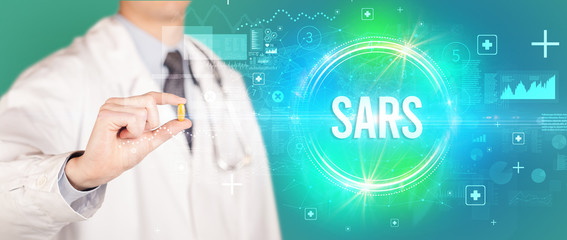 Close-up of a doctor giving you a pill with SARS abbreviation, virology concept