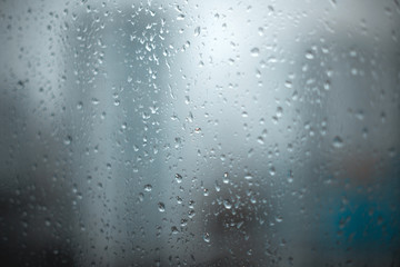 raindrops on a window pane on a cloudy day