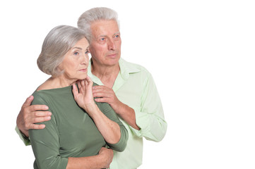 Sad senior couple posing isolated on white background