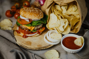 Burger, hamburger with french fries, ketchup, mustard and fresh vegetables 