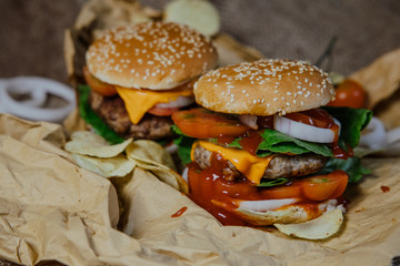 Street food, fast food. Homemade juicy burgers with beef, cheese and caramelized onions