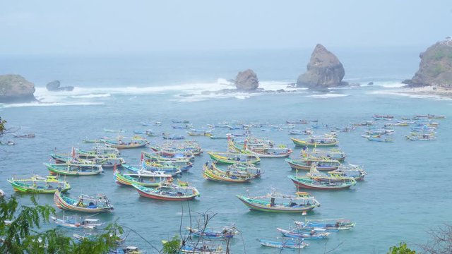 Crowded fisherman boats anchoring at Papuma beach