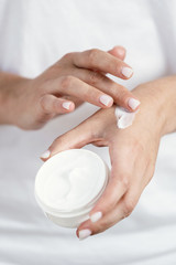 Woman applying soft hand cream on skin - obrazy, fototapety, plakaty