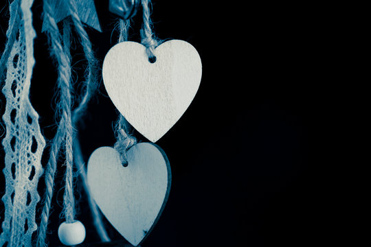 Close-up Of Heart Shape Hanging On Against Black Background