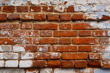 The texture of an orange brick wall with white paint. Brick background and white paint frame