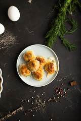 Plate with chicken meatballs, eggs, fresh dill and scattered pepper on a table. Top view kitchen table