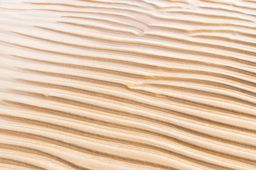 Fototapeta na wymiar Sand texture wave pattern on the beach.