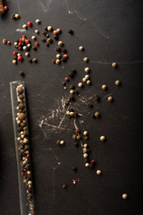 Top view of scattered colorful peppercorns on a kitchen table