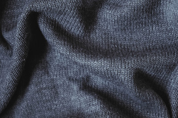 Texture of gray knitted material as background image. Knitting on the knitting needles. Top view. Copy, empty space for text