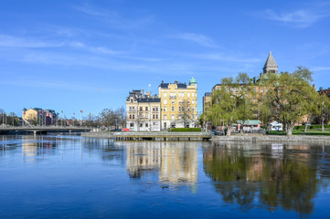 Fototapeta na wymiar Norrkoping waterfront and Motala stream on a sunny spring day in Aril 2020. Norrkoping is a historic industrial town in Sweden.