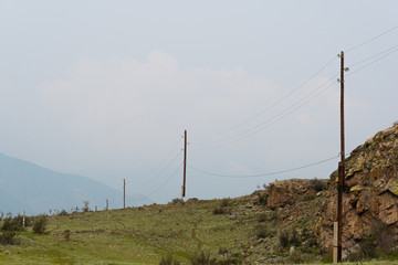 Obraz premium Old wooden poles for power lines in mountainous areas