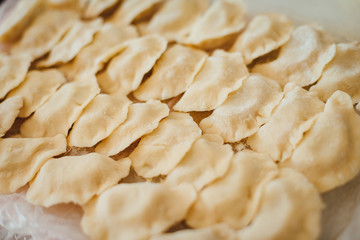 Close-up of handmade raw ukrainian dumplings on the table. Cooking home
