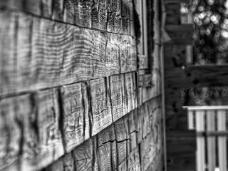 wall of a wooden house made of timber, black and white photo