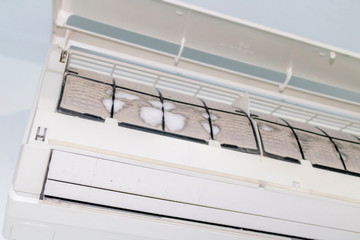 Iced and dusted air conditioner's filter before cleaning by mechanic