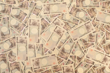 Fototapeta na wymiar 10,000 yen notes - Background with several 10,000 yen notes (front and back). Japanese money. Concept: financial abundance. Horizontal shot.