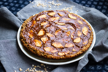 Chocolate baked apple, fruit, oatmeal and nuts brownie with dip cream spread. Sweet vegan brown dessert cake, pie. Breakfast
