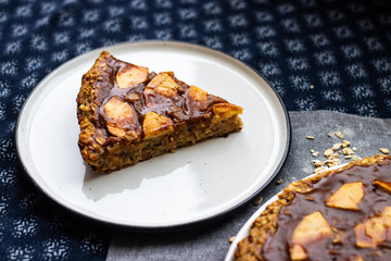 Chocolate baked apple, fruit, oatmeal and nuts brownie with dip cream spread. Sweet vegan brown dessert cake, pie. Breakfast