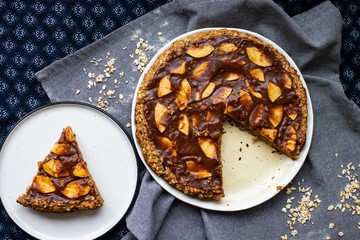 Chocolate baked apple, fruit, oatmeal and nuts brownie with dip cream spread. Sweet vegan brown dessert cake, pie. Breakfast