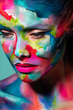 Multicolored skin, difficult to identify. Creative makeup and drawing on the face.