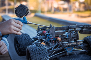 Boy cleaning his RC car with an air compressor