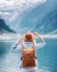Travel image. Traveler look on the mountain lake. Travel and active life concept. Adventure and...