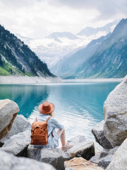 Travel image. Traveler look on the mountain lake. Travel and active life concept. Adventure and travel in the mountains region in the Austria.
