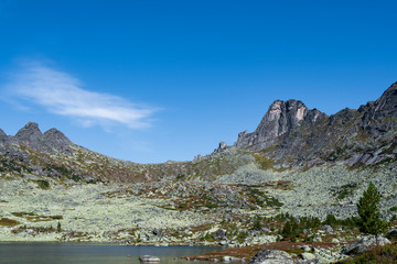 lake under rock ridge, autumn hiking in mountain valley